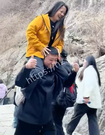 男子爬黄山把老婆扛在肩上